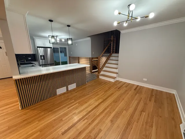 a view of a room with wooden floor and staircase