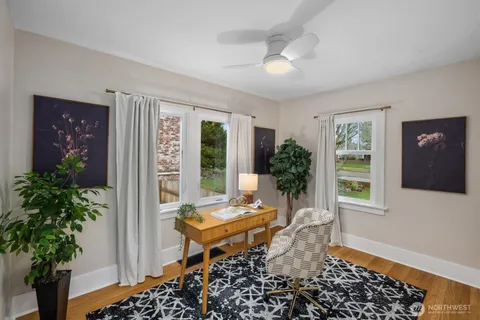 a living room with furniture and a potted plant