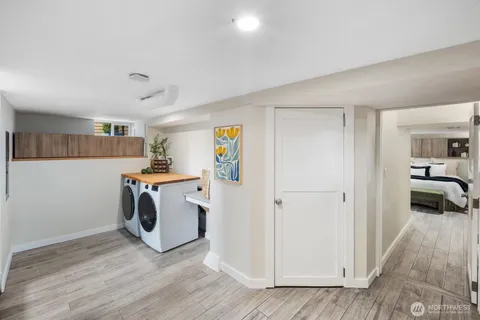 a view of a kitchen with refrigerator and wooden floor