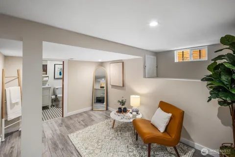 a living room with furniture and a potted plant