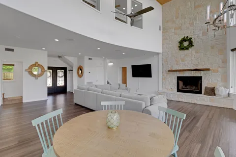 a living room with fireplace furniture and a wooden floor