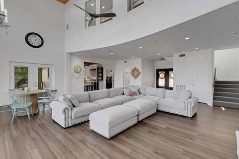 a living room with furniture and wooden floor