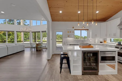 a kitchen with stainless steel appliances granite countertop lots of counter space dining table and chairs