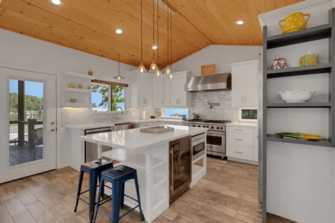 a kitchen with a stove a refrigerator and a microwave