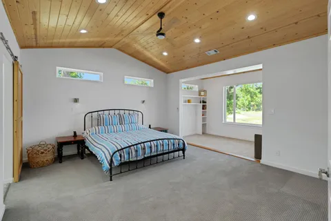 a spacious bedroom with a bed and a window