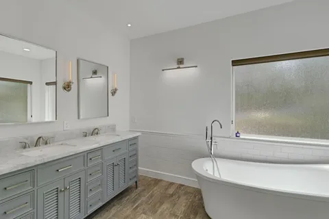 a bathroom with a double vanity sink and a