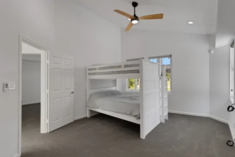 a bedroom with a bed and ceiling fan