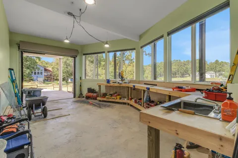 a living room with furniture and floor to ceiling windows