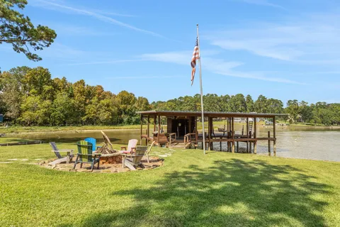 a view of a lake with a table and chairs