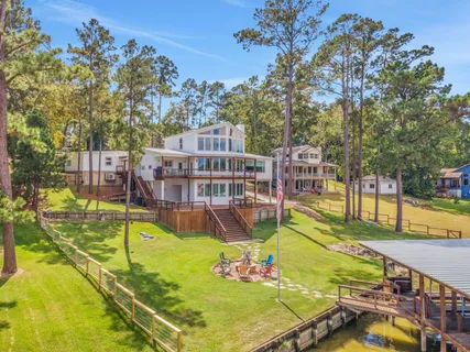 a view of a swimming pool with a patio and a yard
