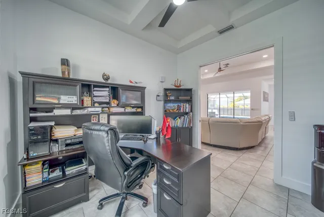 a view of a workspace with furniture and a window