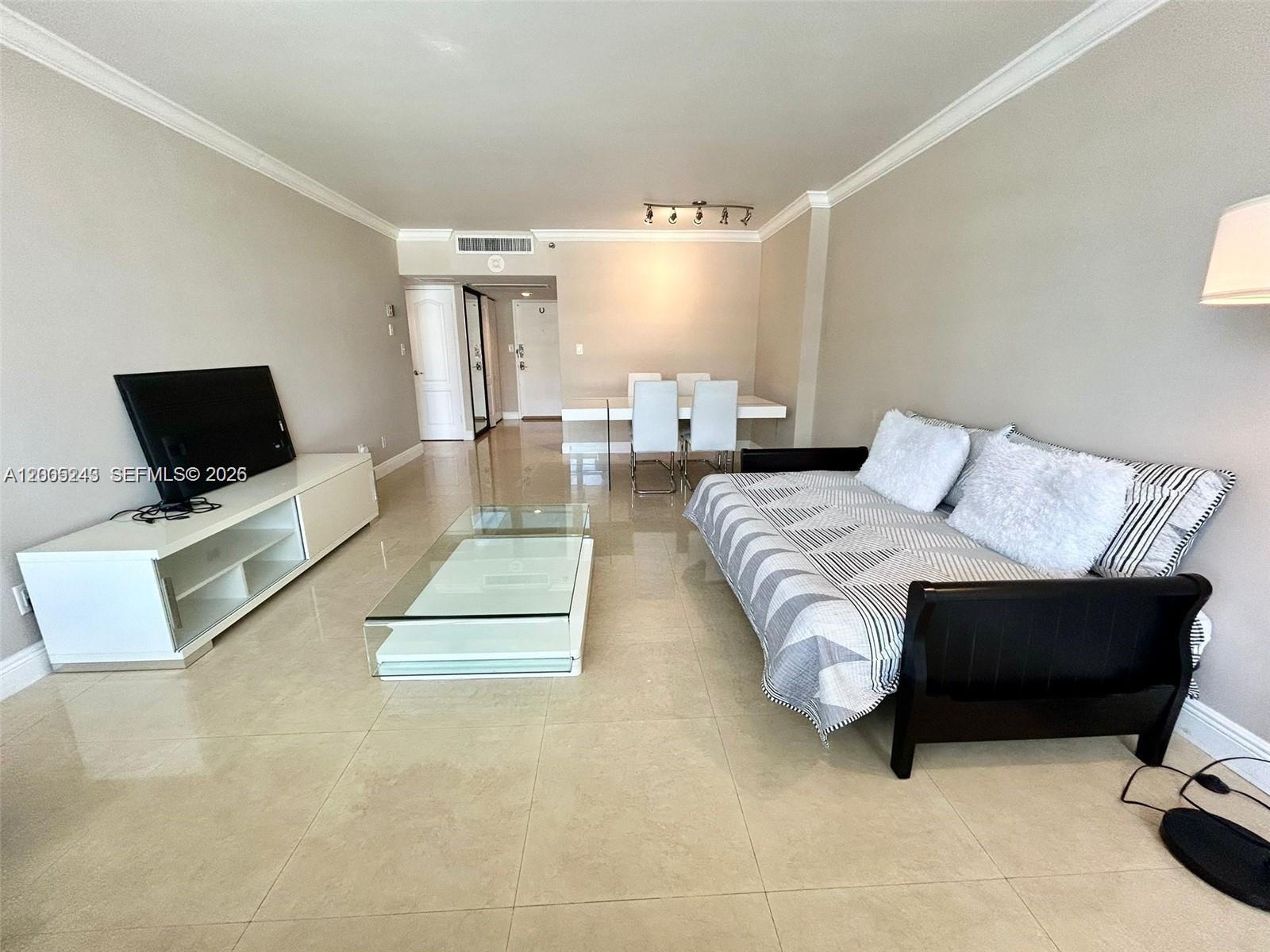 100 Lincoln Road, Unit 1010 Miami Beach, FL 33139 - Photo 2 of 12 a living room with furniture and a flat screen tv