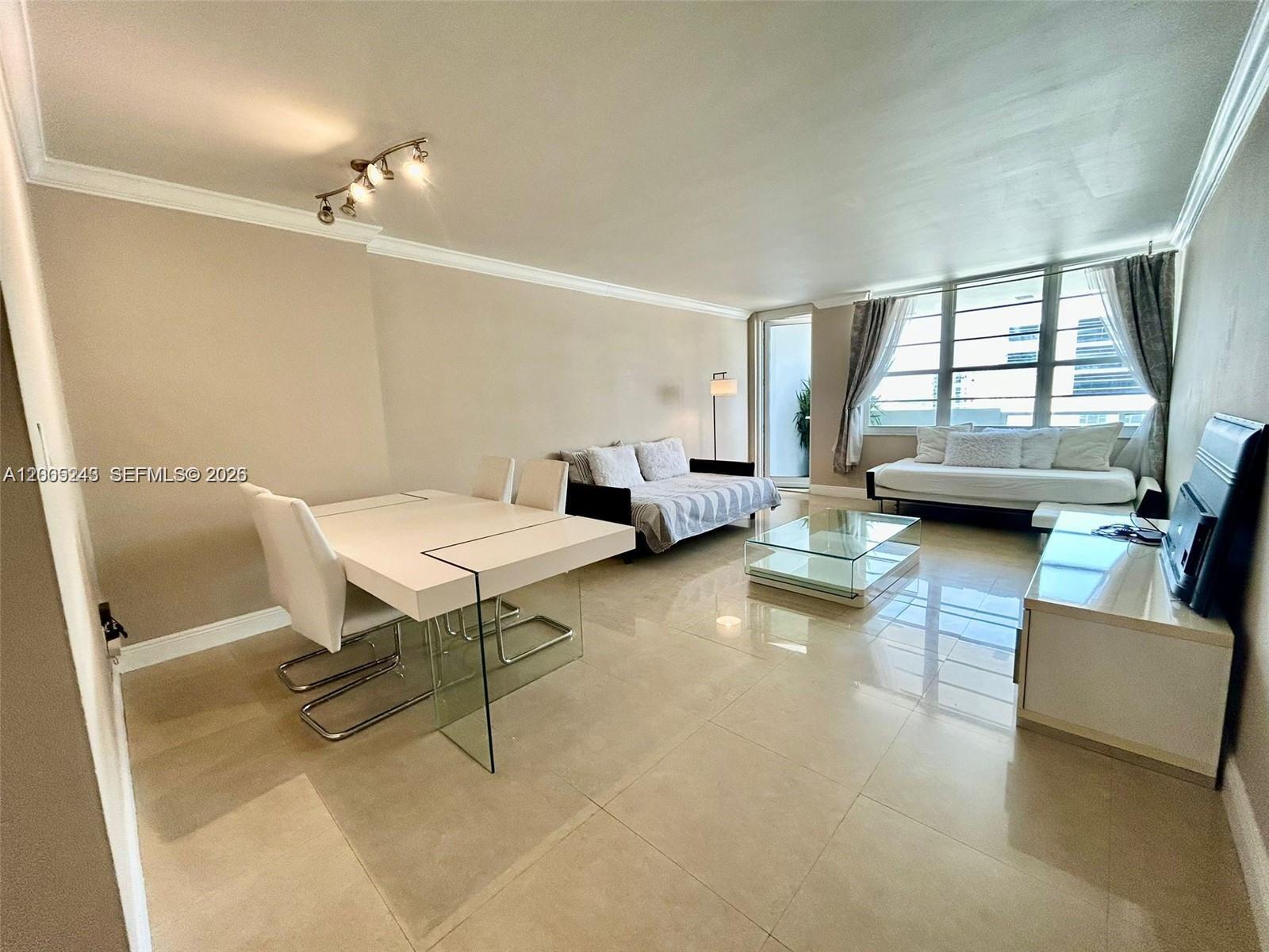 100 Lincoln Road, Unit 1010 Miami Beach, FL 33139 - Photo 3 of 12 a view of a livingroom with furniture and a window