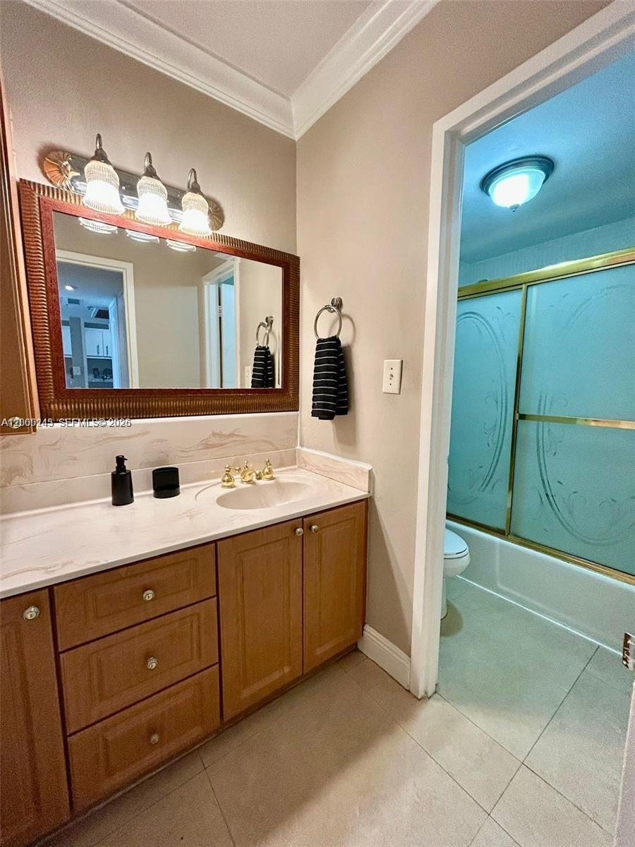 100 Lincoln Road, Unit 1010 Miami Beach, FL 33139 - Photo 9 of 12 a bathroom with a sink and a mirror