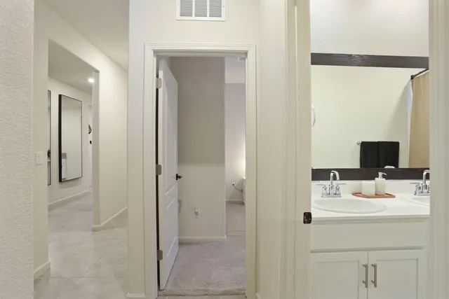 a kitchen with stainless steel appliances granite countertop a sink a stove a refrigerator and cabinets