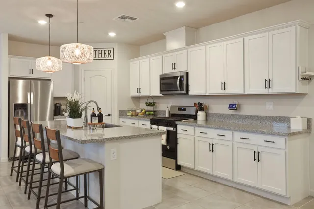 a kitchen with stainless steel appliances granite countertop a sink and cabinets