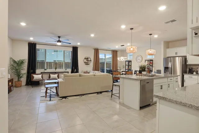 a kitchen with stainless steel appliances granite countertop a sink a stove oven a counter space and cabinets