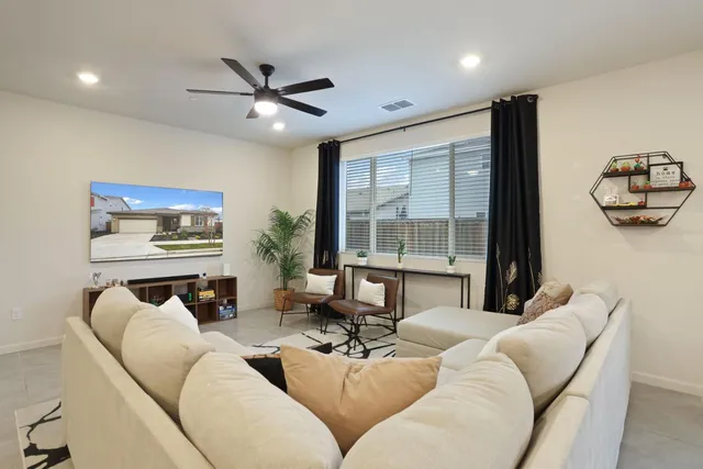 a view of kitchen with kitchen island white cabinets and stainless steel appliances