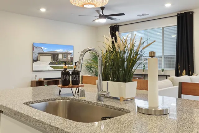 a bedroom with a bed tv and a window