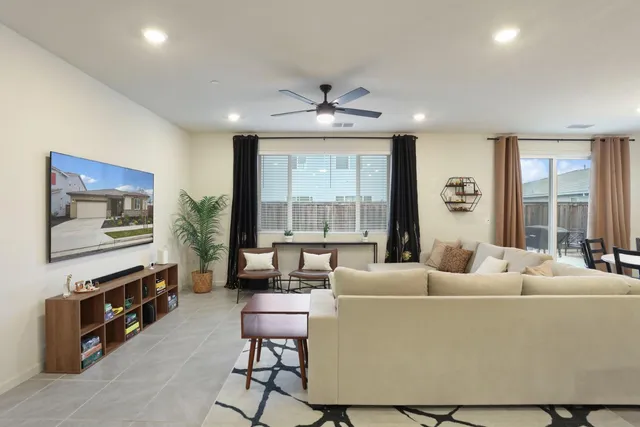 a bedroom with a bed and a ceiling fan