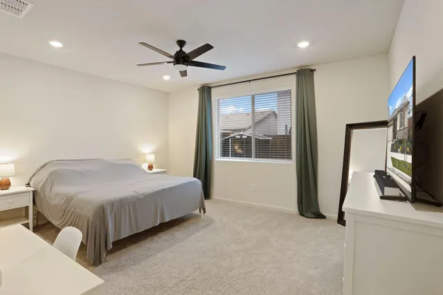 a large white kitchen with lots of counter space a sink appliances and cabinets