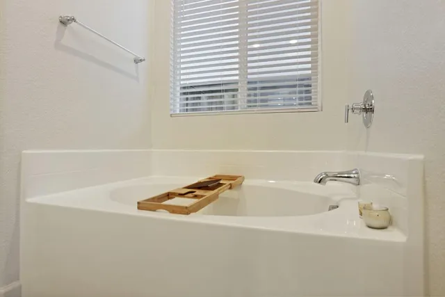 a view of walk in closet with clothes