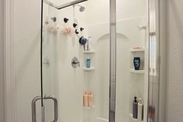 a en suite bathroom with a double vanity sink a mirror and a shower