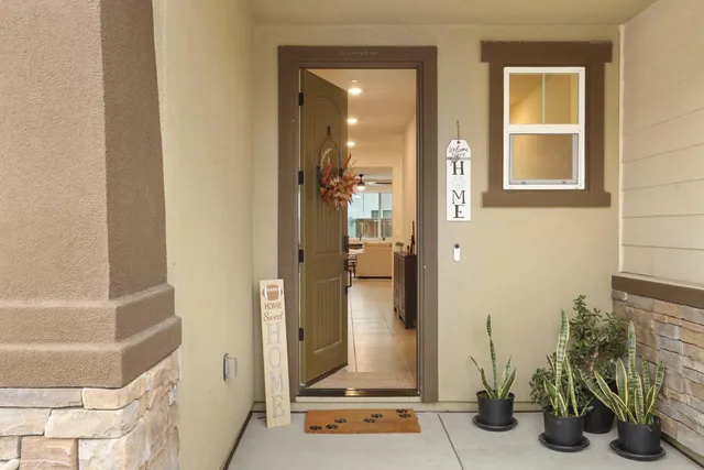a view of a hallway with a livingroom and furniture