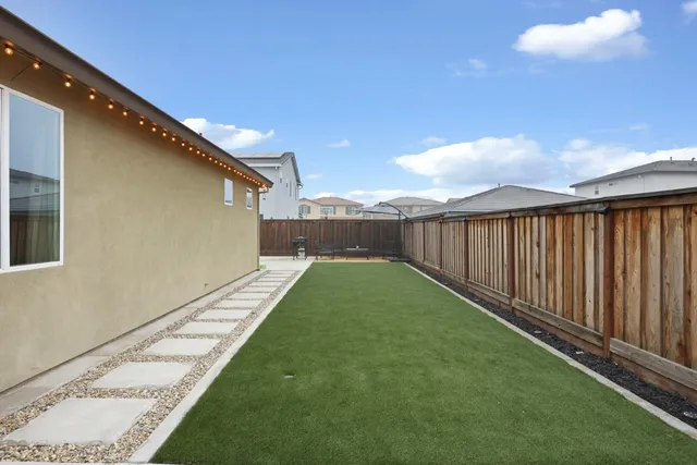 a backyard of a house with outdoor seating
