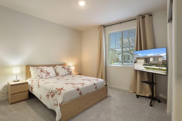 a bedroom with a bed and a window