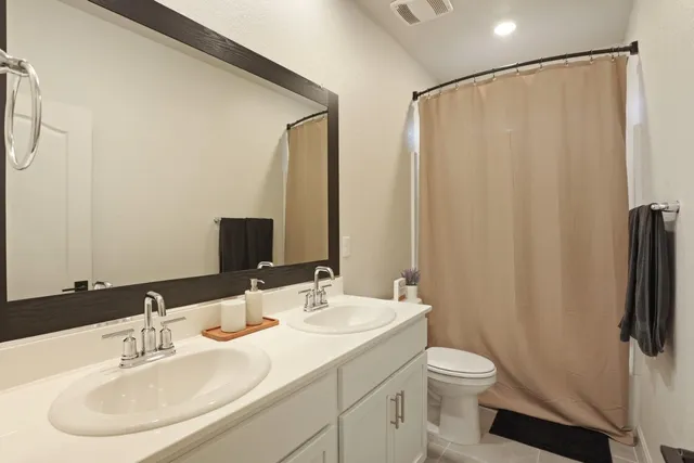 a bedroom with a bed wall painting and a window