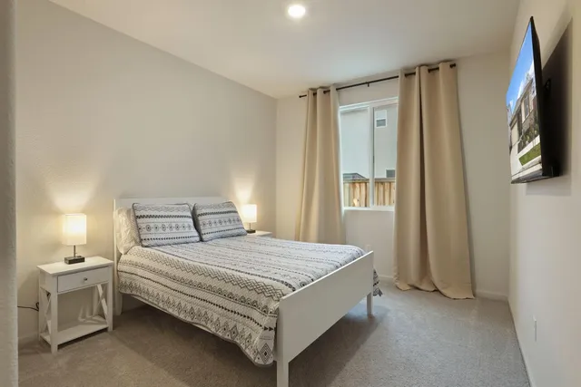 a bedroom with a bed and a window