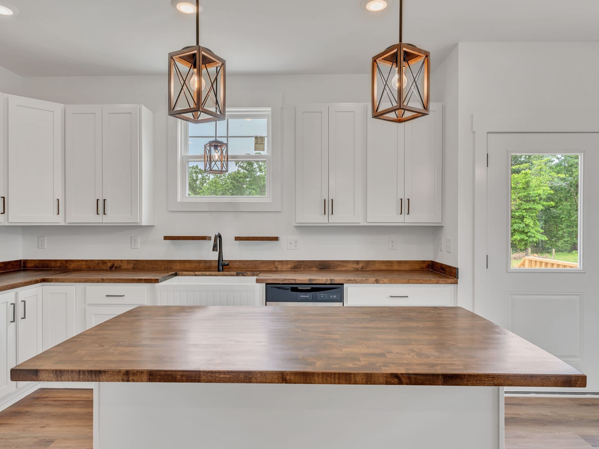 5800 Sanders Road Lyles, TN 37098 - Photo 10 of 28 a kitchen with stainless steel appliances granite countertop a sink a stove and a wooden floors