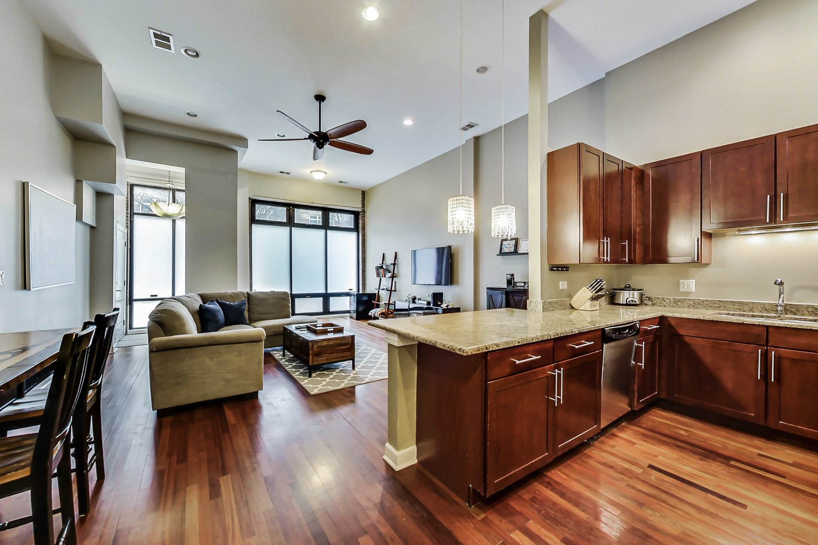2122 West Rice Street, Unit 1 Chicago, IL 60622 - Photo 12 of 22 a large kitchen with stainless steel appliances granite countertop a lot of counter space and wooden floors