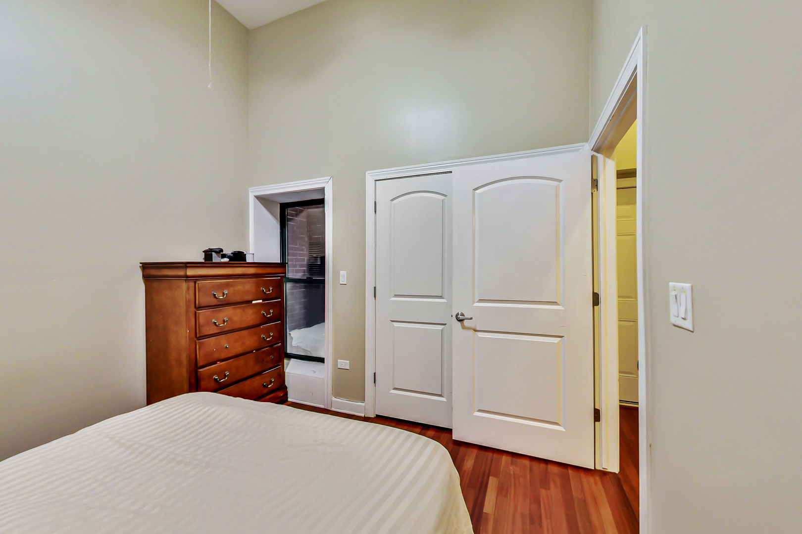 2122 West Rice Street, Unit 1 Chicago, IL 60622 - Photo 16 of 22 a bedroom with a bed and a dresser