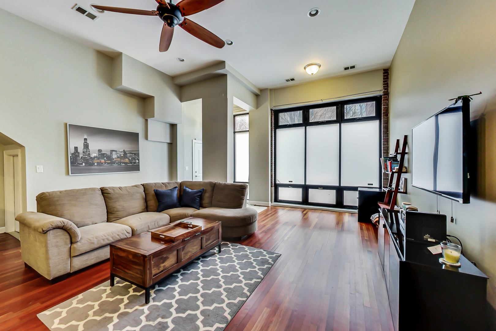 2122 West Rice Street, Unit 1 Chicago, IL 60622 - Photo 4 of 22 a living room with furniture flat screen tv and a large window