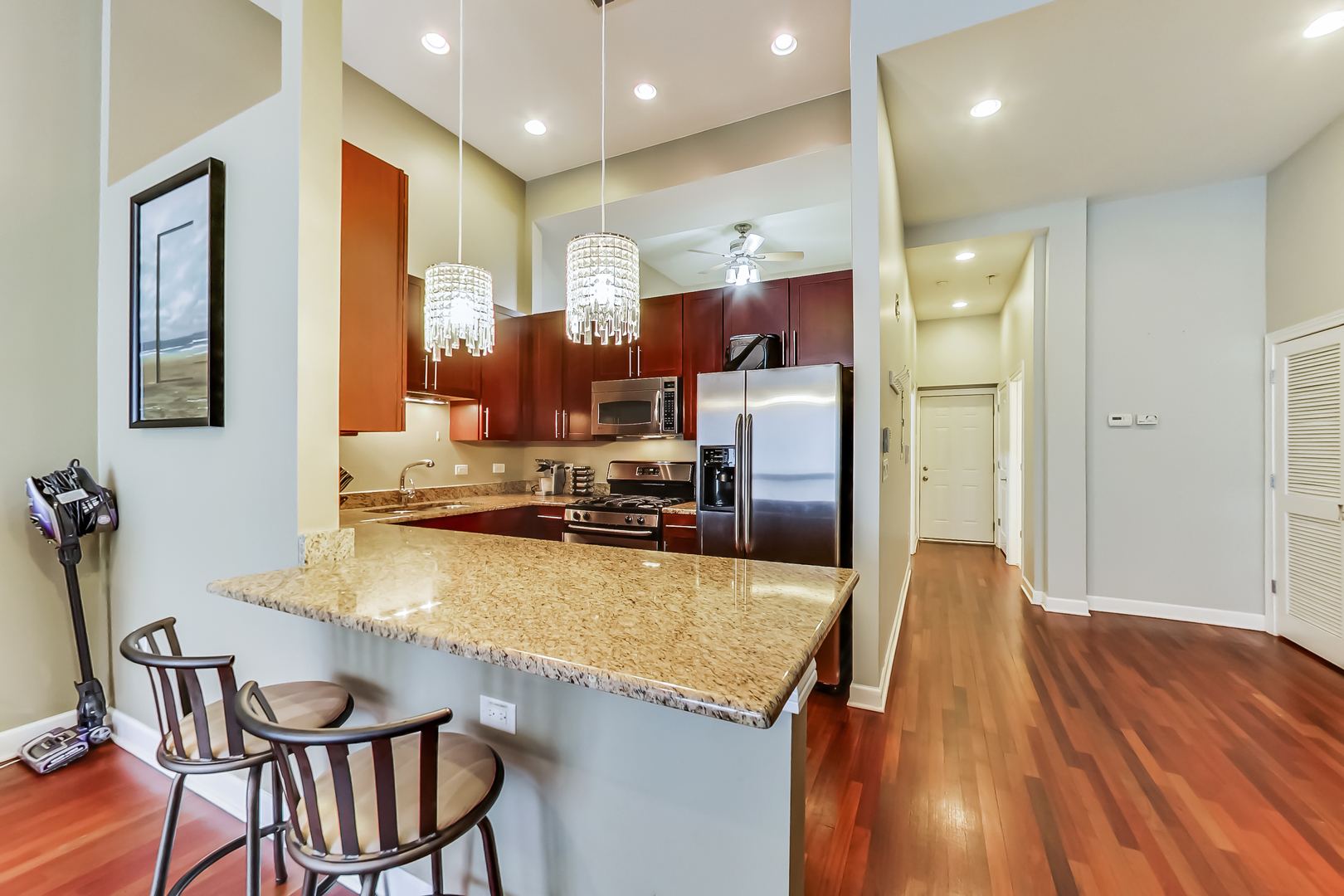 2122 West Rice Street, Unit 1 Chicago, IL 60622 - Photo 9 of 22 a kitchen with a table chairs refrigerator and microwave