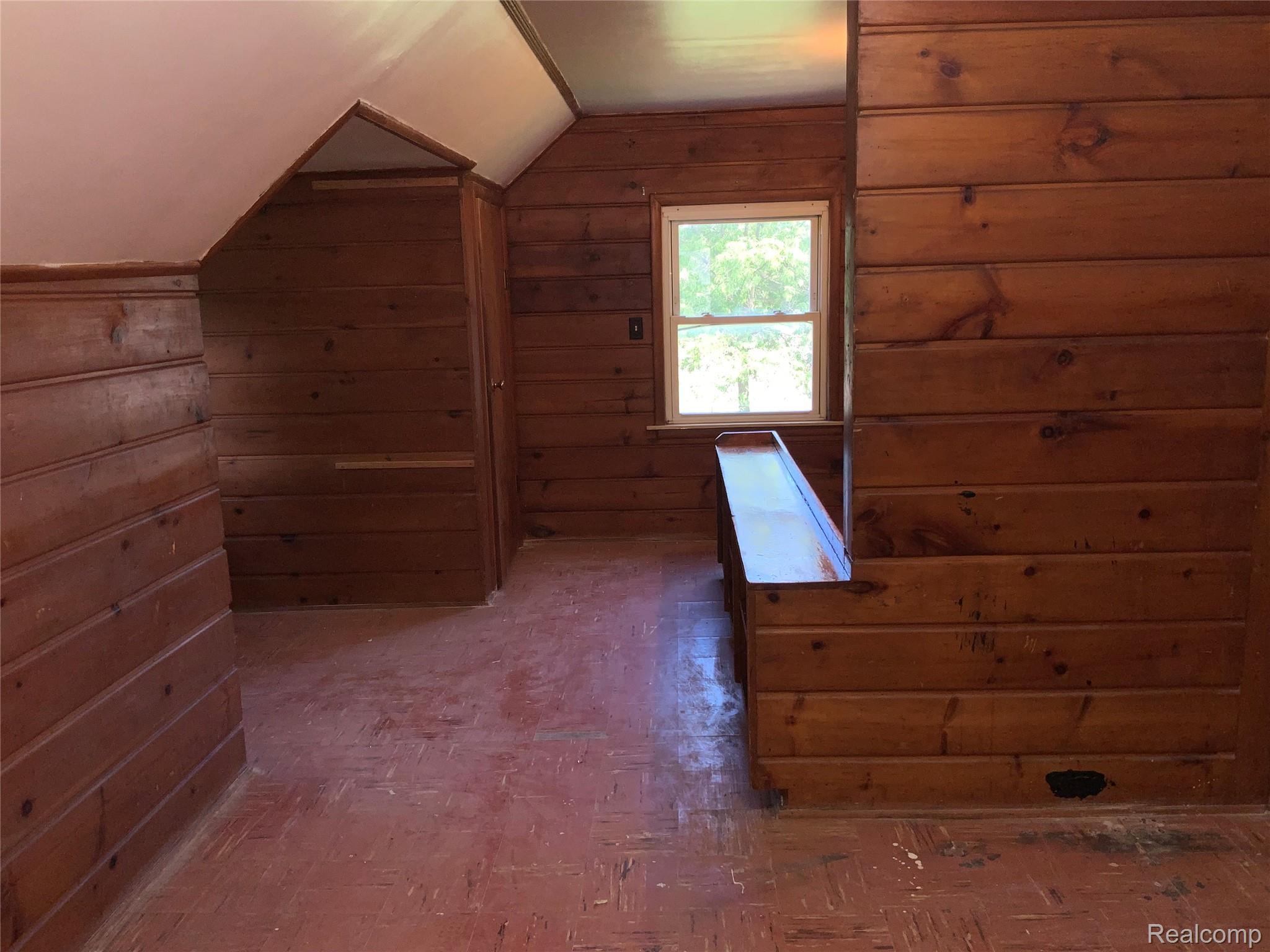 4034 Fleming Road Flint, MI 48504 - Photo 18 of 20 Knotty pine paneling throughout, gabled ceiling, and a single pane window