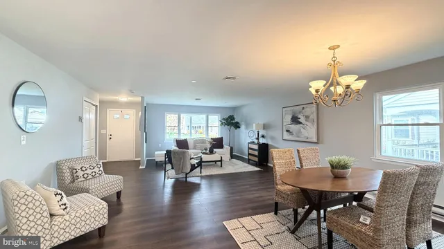 a view of a room with furniture and wooden floor