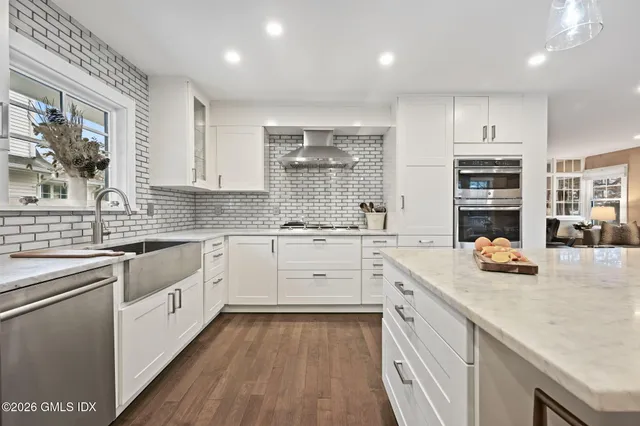 a kitchen with a white cabinets and window