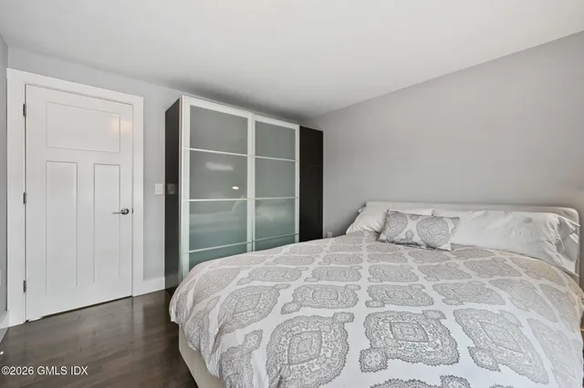 a bathroom with a toilet a sink a window and mirror