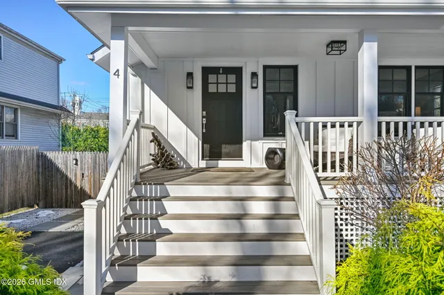 a front view of a house with a garden and balcony
