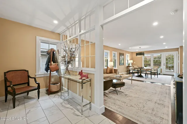 a living room with furniture and a dining table with rug floor
