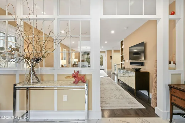 a large kitchen with stainless steel appliances kitchen island granite countertop a refrigerator and a stove