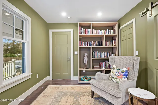 a living room with furniture and a book shelf