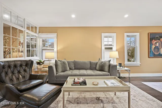 a living room with furniture and a flat screen tv with wooden floor