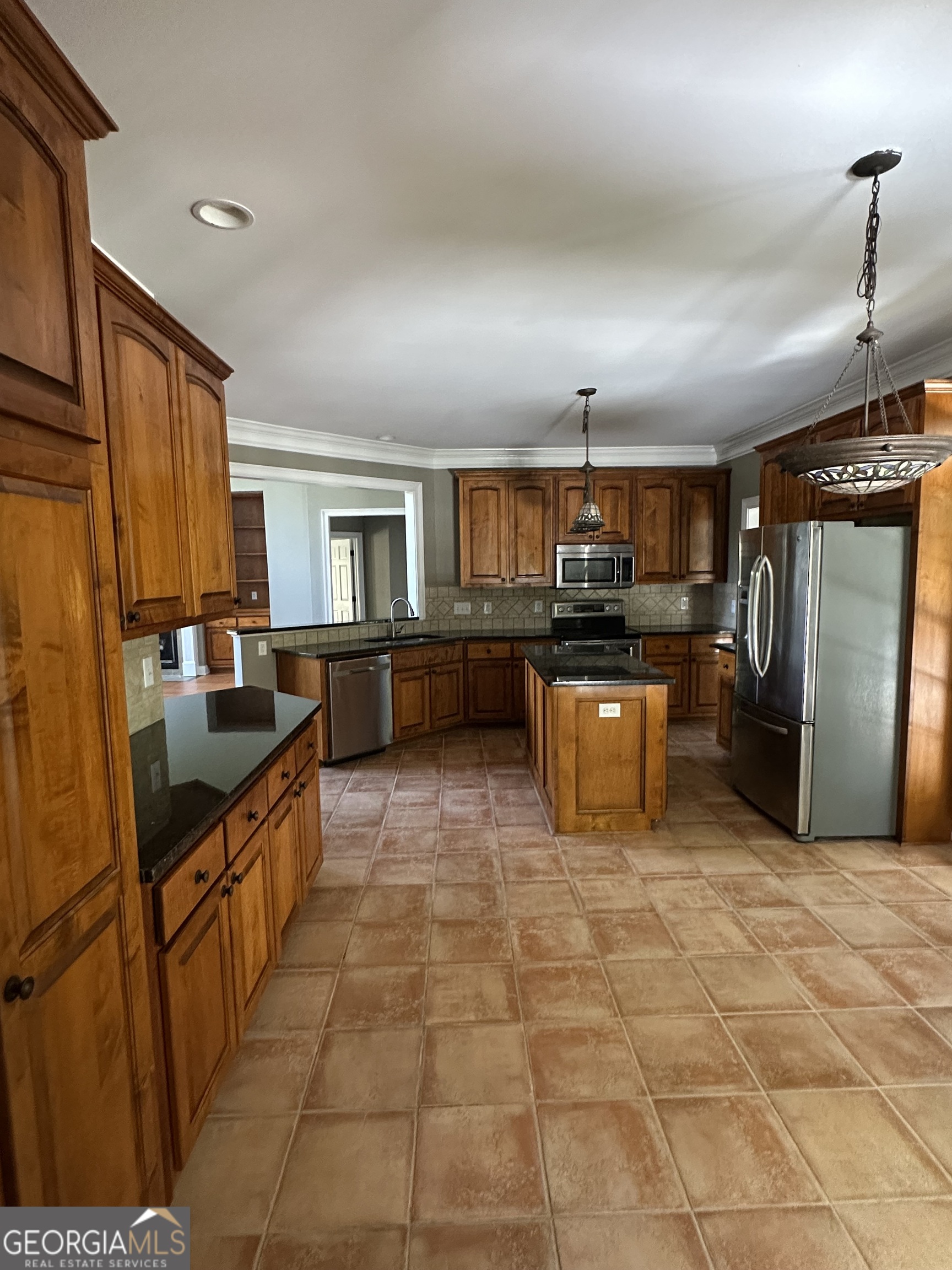 65 Spratlin Way Hull, GA 30646 - Photo 15 of 35 a large kitchen with granite countertop a large counter top stainless steel appliances a stove a sink a counter top space and cabinets