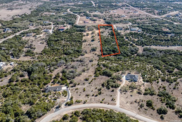 an aerial view of residential houses with city view