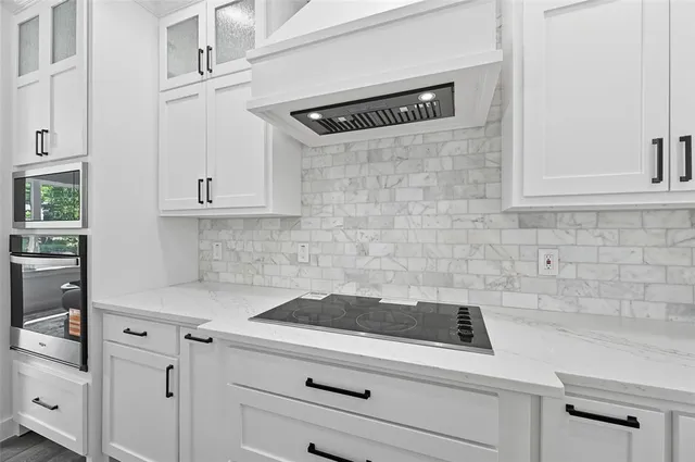 a kitchen with white cabinets and white appliances