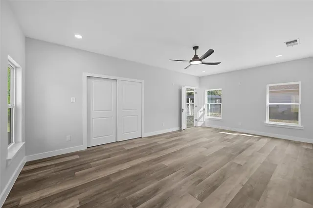 wooden floor in an empty room with a window